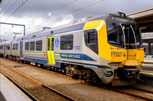A Metlink electric train sits at a railway station platform in Wellington, displaying destination information on its front panel.