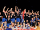 Wellington Saints players and staff celebrating their NBL championship win on court at TSB Arena.