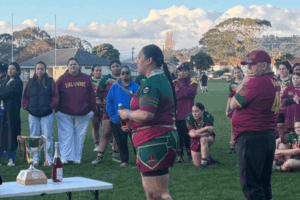 Porirua Valkyrie women's rugby league team celebrating with the Aggy Memorial Cup