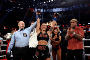 Cherneka Johnson raises her arms in victory after winning the undisputed bantamweight world title at Madison Square Garden.