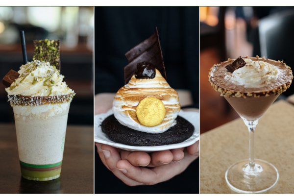 Three indulgent chocolate-themed desserts: a pistachio-topped milkshake with whipped cream, a chocolate tart topped with toasted meringue and a gold chocolate coin, and a chocolate cocktail rimmed with nuts and garnished with whipped cream and chocolate pieces.