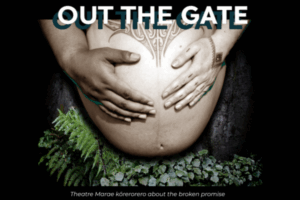 Hands cradling a pregnant belly with tā moko, surrounded by native ferns and plants.