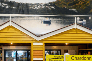 Interior view of Moore Wilson’s Porirua with yellow replica boatshed facades and a large mural of Mana Island and boats in the background