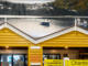 Interior view of Moore Wilson’s Porirua with yellow replica boatshed facades and a large mural of Mana Island and boats in the background