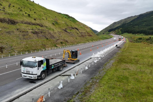 Construction vehicles and traffic cones along State Highway 1 Transmission Gully during summer maintenance to upgrade drainage and improve road safety.