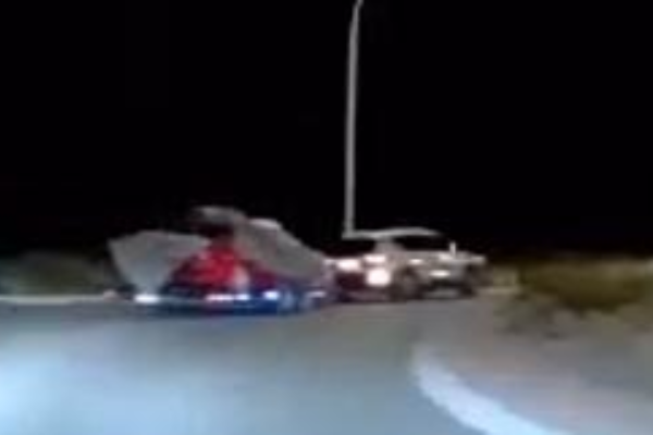 Police appeal for information about a white SUV towing a red Holden on Transmission Gully.