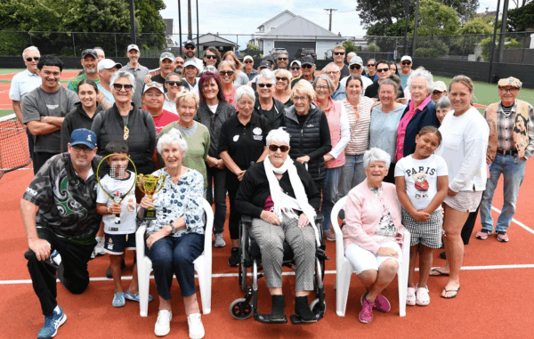 Members and supporters of Titahi Bay Tennis Club gather on the courts during centenary celebrations marking 100 years since the club was founded.