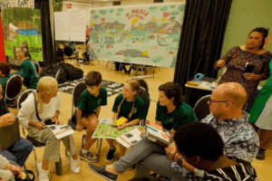 Makerita Makepelu, Team Manager of Innovation Practice at Te Hiko and co-facilitator of the Assembly (top right) encourages group discussion.