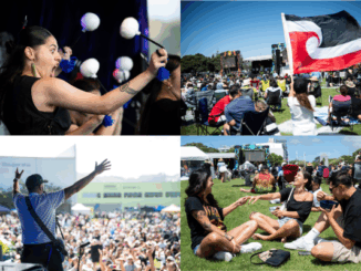 Crowds gather at an outdoor festival in Porirua, with performers on stage and people seated on the grass, some holding a tino rangatiratanga flag.