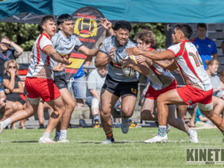 Paremata-Plimmerton player is tackled by multiple Hutt Old Boys Marist defenders during the National Club Sevens at Ngāti Toa Domain.