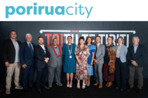 Porirua Mayor Anita Baker and city councillors pose for an official group photo in front of Porirua City branding.