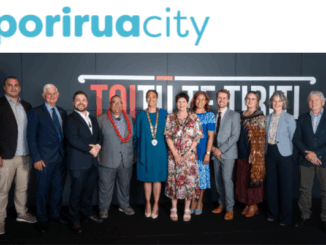 Porirua Mayor Anita Baker and city councillors pose for an official group photo in front of Porirua City branding.