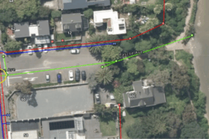 Aerial map showing Pascoe Avenue and surrounding properties in Paremata, with coloured lines marking underground wastewater and stormwater infrastructure near the shoreline.