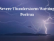 Lightning strikes over Porirua harbour beneath a dark stormy sky, with bold text reading “Severe Thunderstorm Warning Porirua”.
