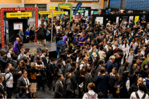 Crowds of secondary school students and jobseekers fill Te Rauparaha Arena during the Porirua Careers Expo, visiting exhibitor stalls and speaking with employers and training providers.