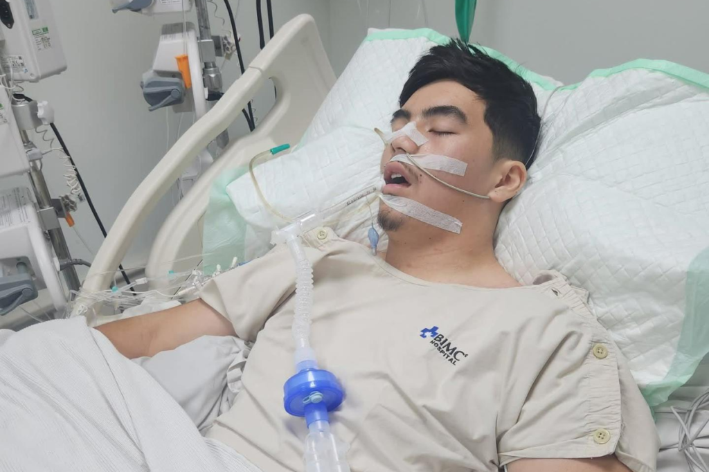 Ashen Phaipanya lies in a hospital bed in Bali ICU with medical tubes attached while being treated for meningitis.