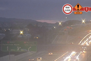 Traffic queues on State Highway 1 near Porirua, with a road closed crash warning graphic shown on the image.