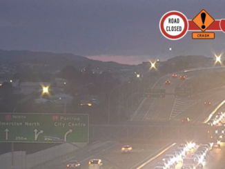 Traffic queues on State Highway 1 near Porirua, with a road closed crash warning graphic shown on the image.