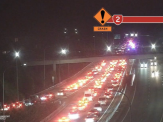 Traffic backed up on State Highway 2 at night after a crash near the Haywards interchange, with emergency lights visible ahead.