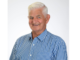 Portrait of Porirua City Councillor Mike Duncan smiling in a blue checked shirt.
