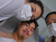 Ashen Phaipanya smiling in a hospital bed in Bali with his parents, Sheena and Ants, beside him.