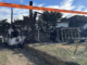 Fire-damaged house in Spur Grove, Tītahi Bay, behind danger tape after a Saturday night blaze.