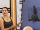 A student presents Te Manawa design concepts beside a screen showing a courtyard proposal.