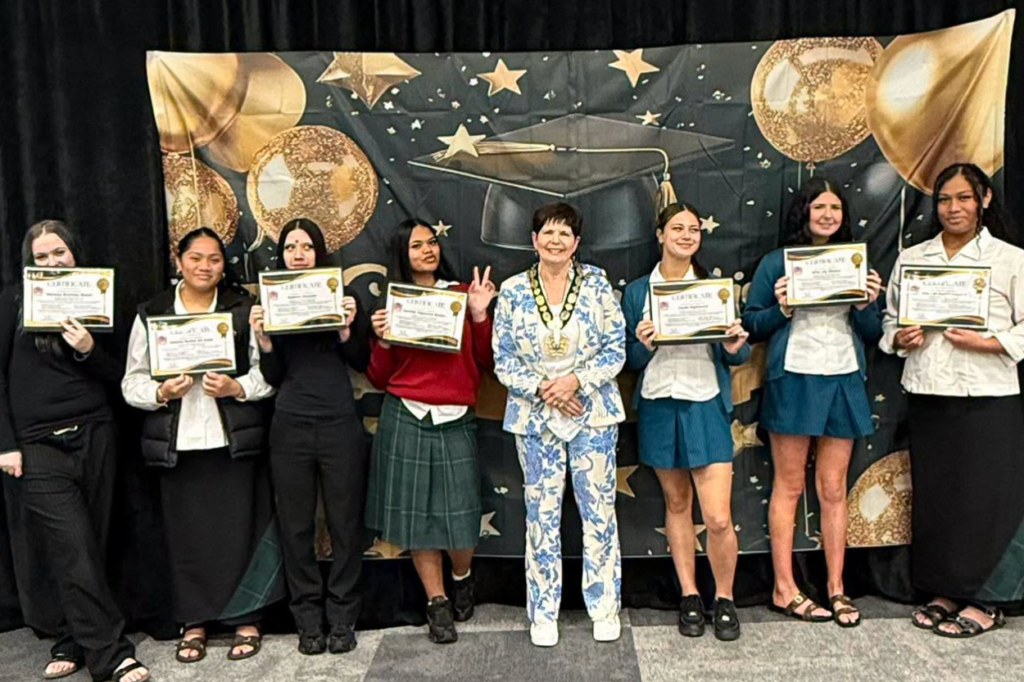 Graduates hold certificates beside Porirua Mayor Anita Baker at the Polynesian Beauty Academy Gateway Class Graduation.