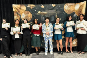 Graduates hold certificates beside Porirua Mayor Anita Baker at the Polynesian Beauty Academy Gateway Class Graduation.