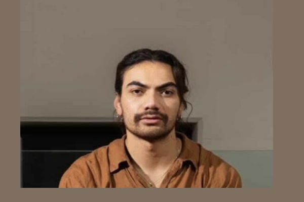 Close-up portrait of Kasi Valu wearing a rust-brown shirt.