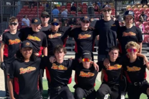 Twelve Paremata Plimmerton Softball Club members pose together in black ParePlim shirts at a softball ground.