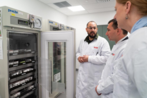 Wellington Blood Bank team leader Dan Gyles speaks with Health Minister Simeon Brown beside an open refrigerated blood storage unit.