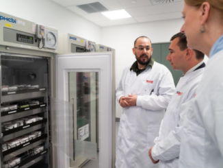Wellington Blood Bank team leader Dan Gyles speaks with Health Minister Simeon Brown beside an open refrigerated blood storage unit.