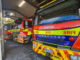 Three red and yellow fire appliances parked inside Porirua Fire Station.
