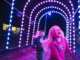 Alt text: Children run through a colourful tunnel of lights at Porirua’s harbourside Matariki light display.