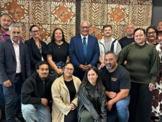 A group of Partners Porirua Trust representatives pose together indoors in front of a patterned wall hanging.