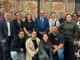 A group of Partners Porirua Trust representatives pose together indoors in front of a patterned wall hanging.