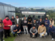 Porirua Whānau Centre Programmes Manager TJ Fermanis (front row, squatting) with a group of rangatahi taking part in the He Poutama Rangatahi work readiness programme, gathered around the programme's food truck in Cannons Creek.