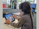A Porirua primary school student wearing headphones completes a listening activity on a tablet as part of a hearing and auditory processing programme.