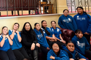 Postgate School students in blue uniforms with MP Debbie Ngarewa-Packer during their visit to Parliament.