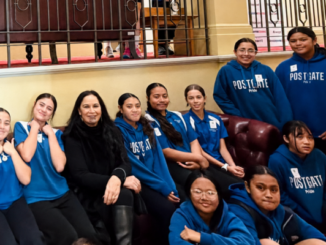 Postgate School students in blue uniforms with MP Debbie Ngarewa-Packer during their visit to Parliament.