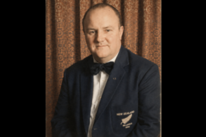 Portrait of Russell Robinson wearing a New Zealand billiards blazer and bow tie.