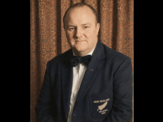 Portrait of Russell Robinson wearing a New Zealand billiards blazer and bow tie.