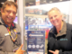 A Noel Leeming staff member and Porirua City Council representative point to a TechCollect NZ e-waste drop-off sign inside Noel Leeming Porirua.