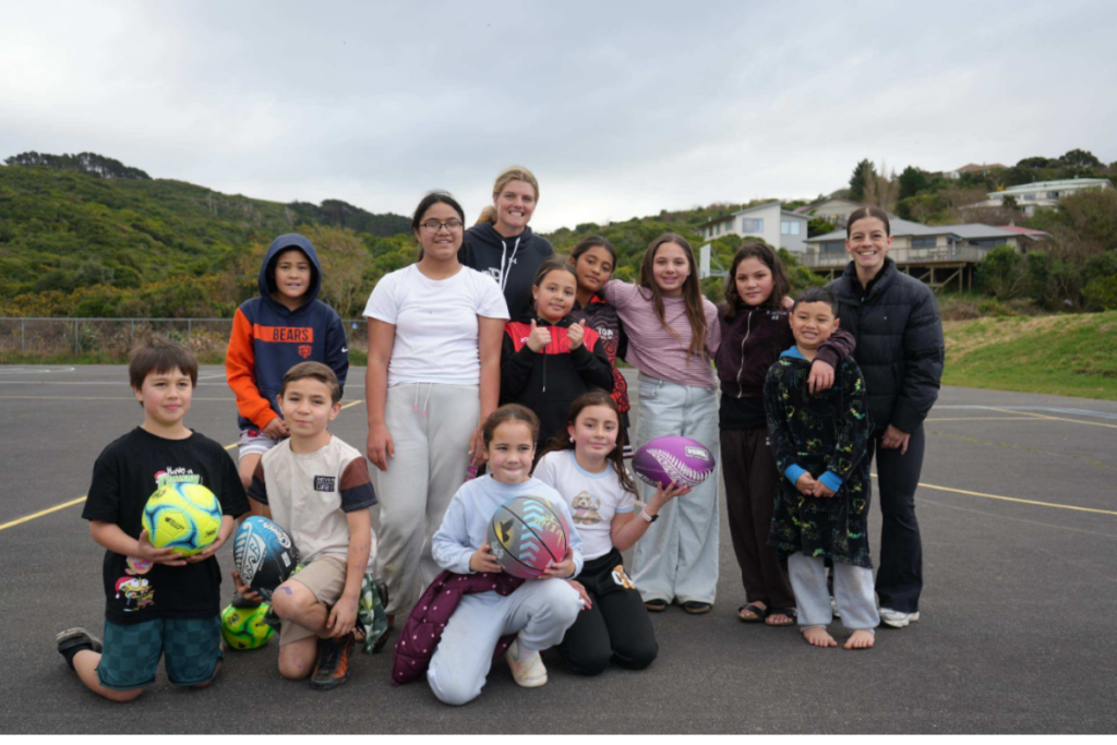 Ngāti Toa School students with tennis player Ayla Giesen and Nuku Ora facilitator Tash Snook after receiving new sports balls.