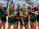 Mana College senior girls basketball team celebrating their College Sport Wellington Premier Girls championship win, with players holding the trophy and wearing medals.