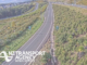 An empty section of divided state highway winding through green hills, with the NZ Transport Agency Waka Kotahi logo in the lower left.