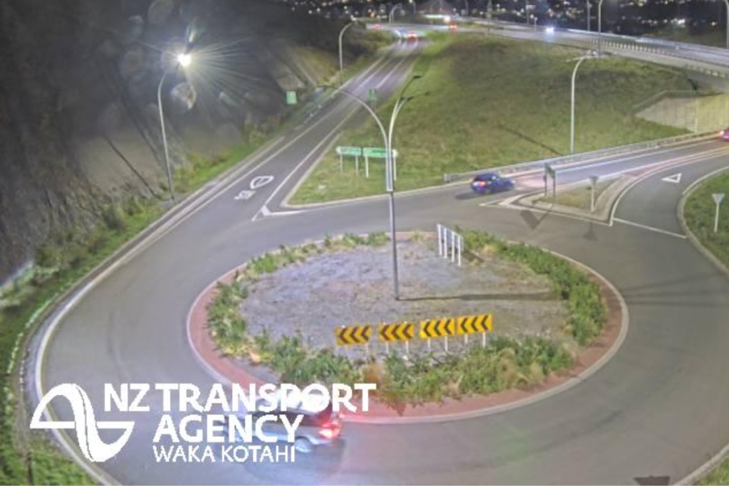 Night-time view of a roundabout and motorway interchange on Transmission Gully near Porirua.