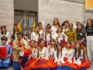 Mana College students and staff pose in cultural clothing during Asian Cultural Week, with two students holding drums.