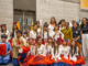 Mana College students and staff pose in cultural clothing during Asian Cultural Week, with two students holding drums.